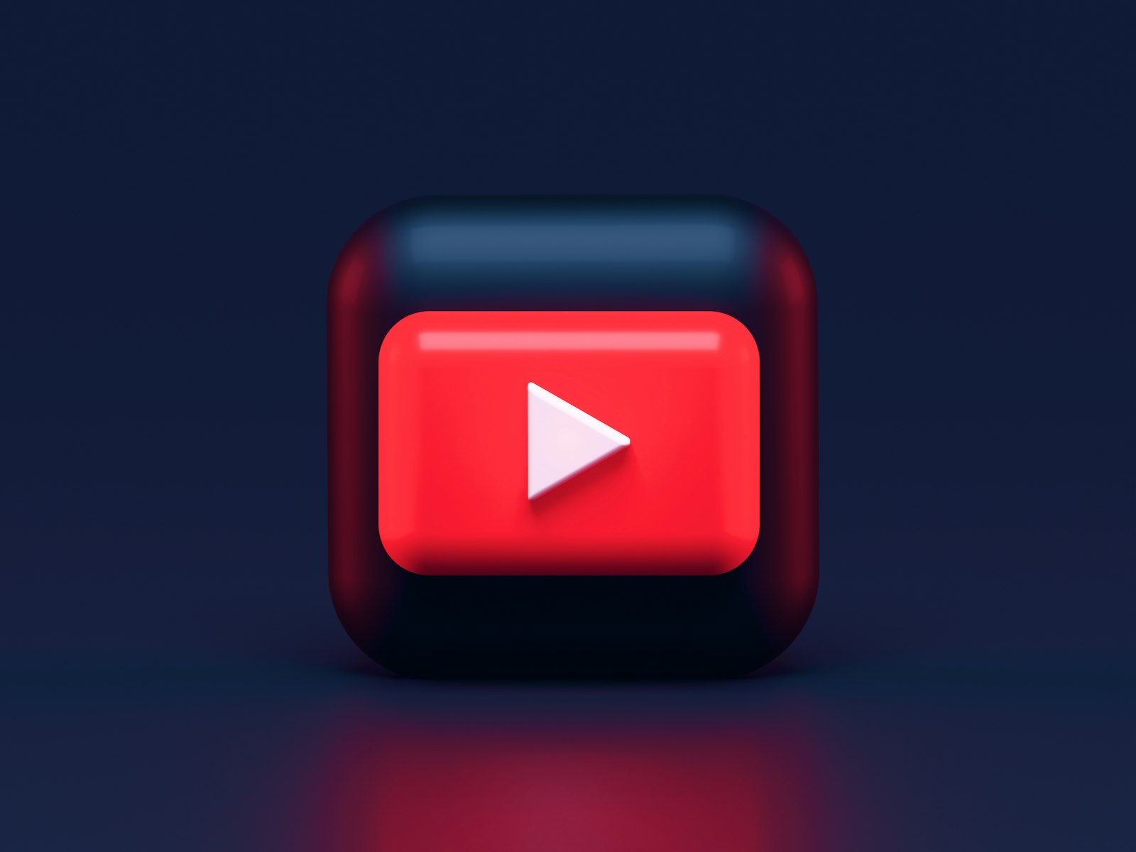 Red 3D play button on dark background