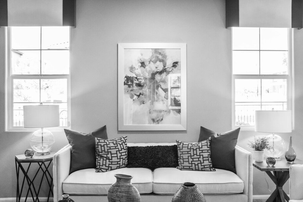 Cream sofa with blue cushions and framed art