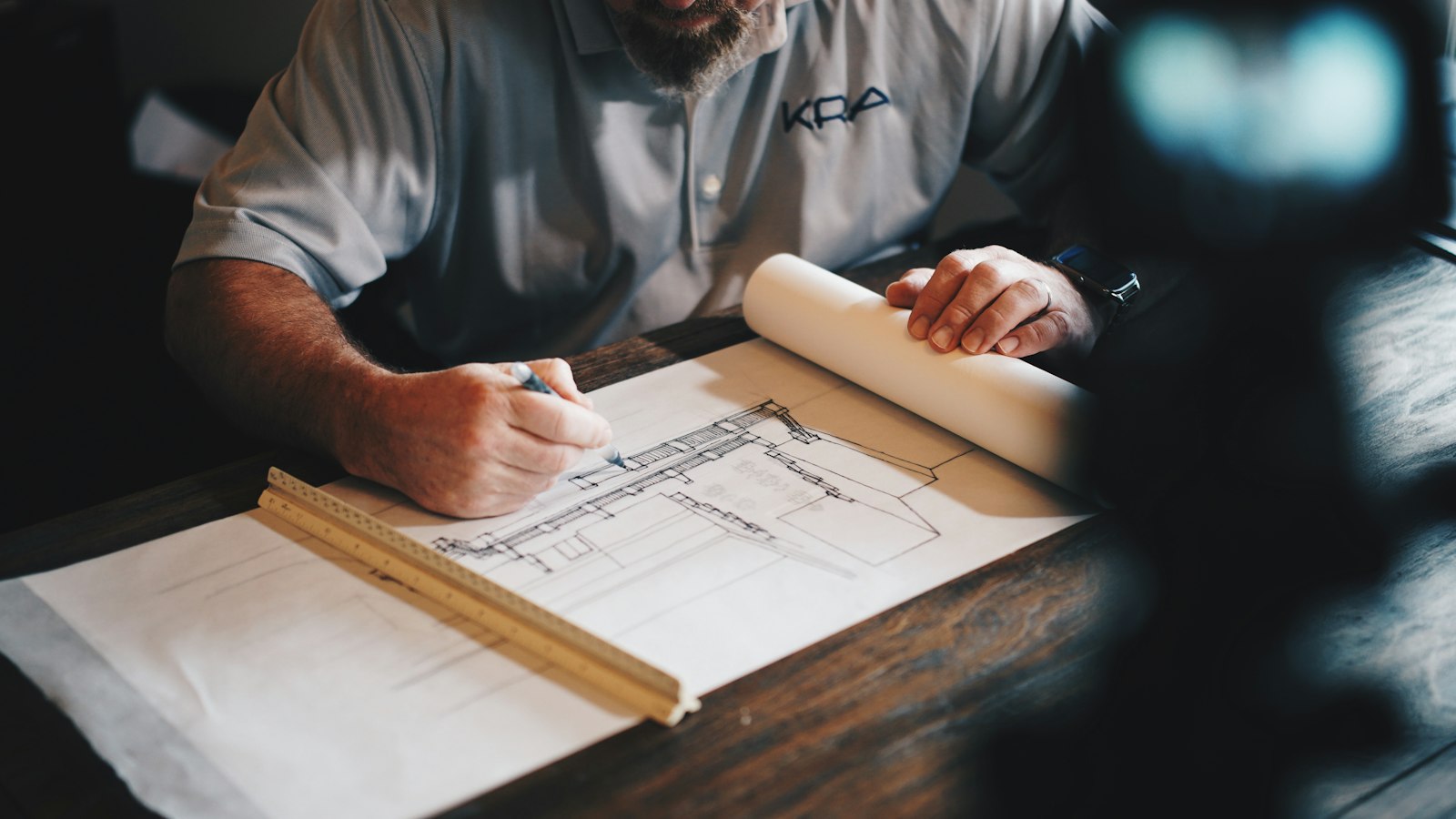 Blueprints and laptop on a work desk