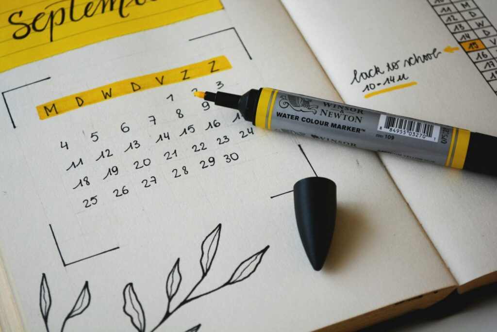 Hand-drawn calendar in a notebook with yellow marker