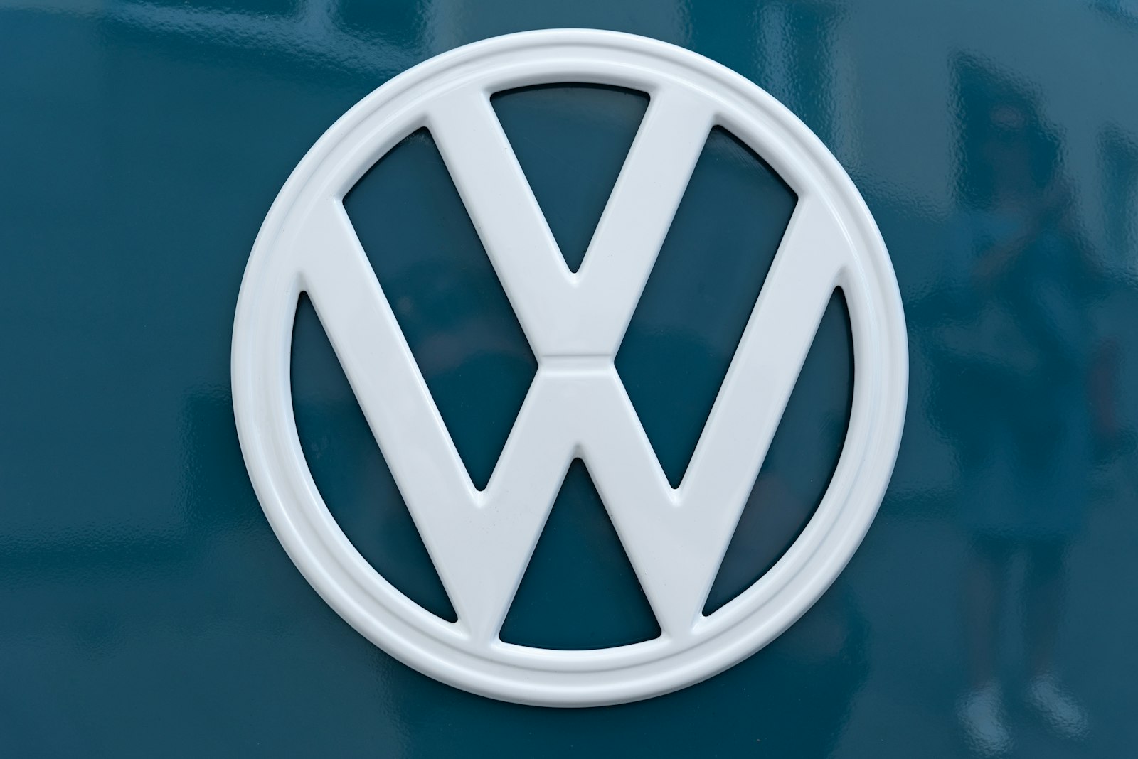 Close-up of a Volkswagen emblem on blue bodywork