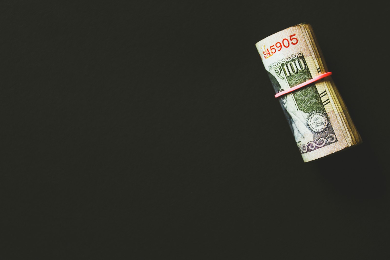 Rolled banknotes on a dark surface