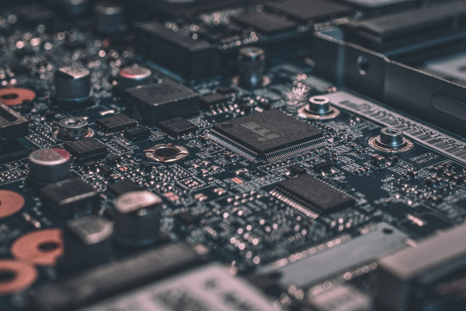 Close-up of a circuit board with a central processor and copper coils