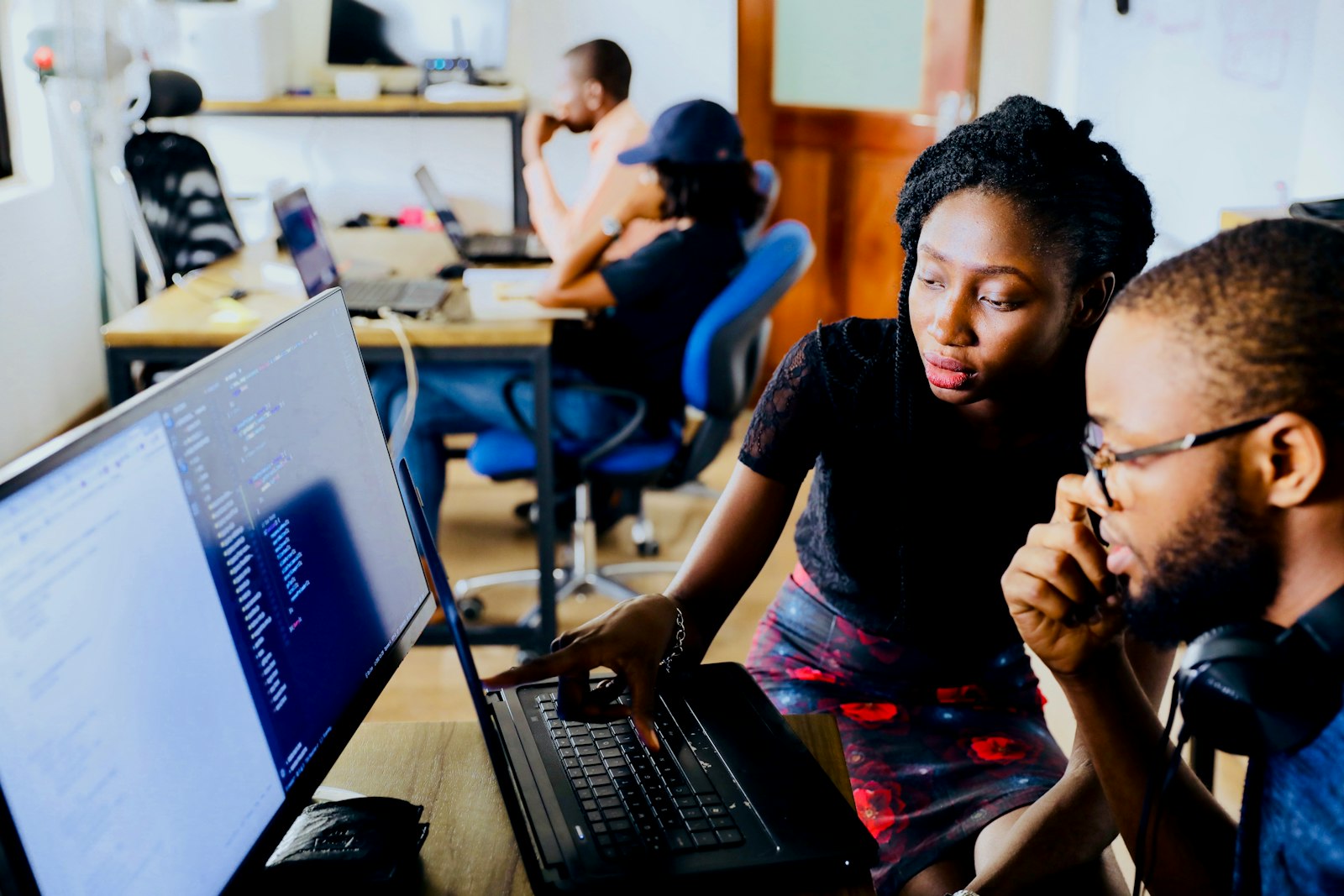 Students at laptops in a coding class