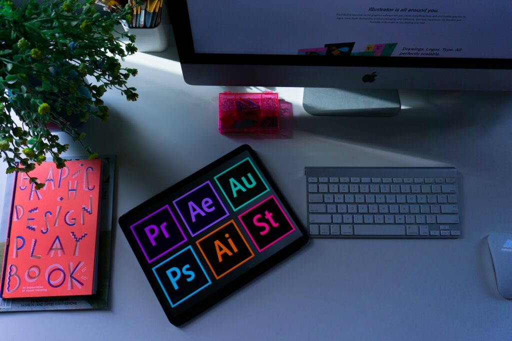 Desk with tablet showing colorful design app icons
