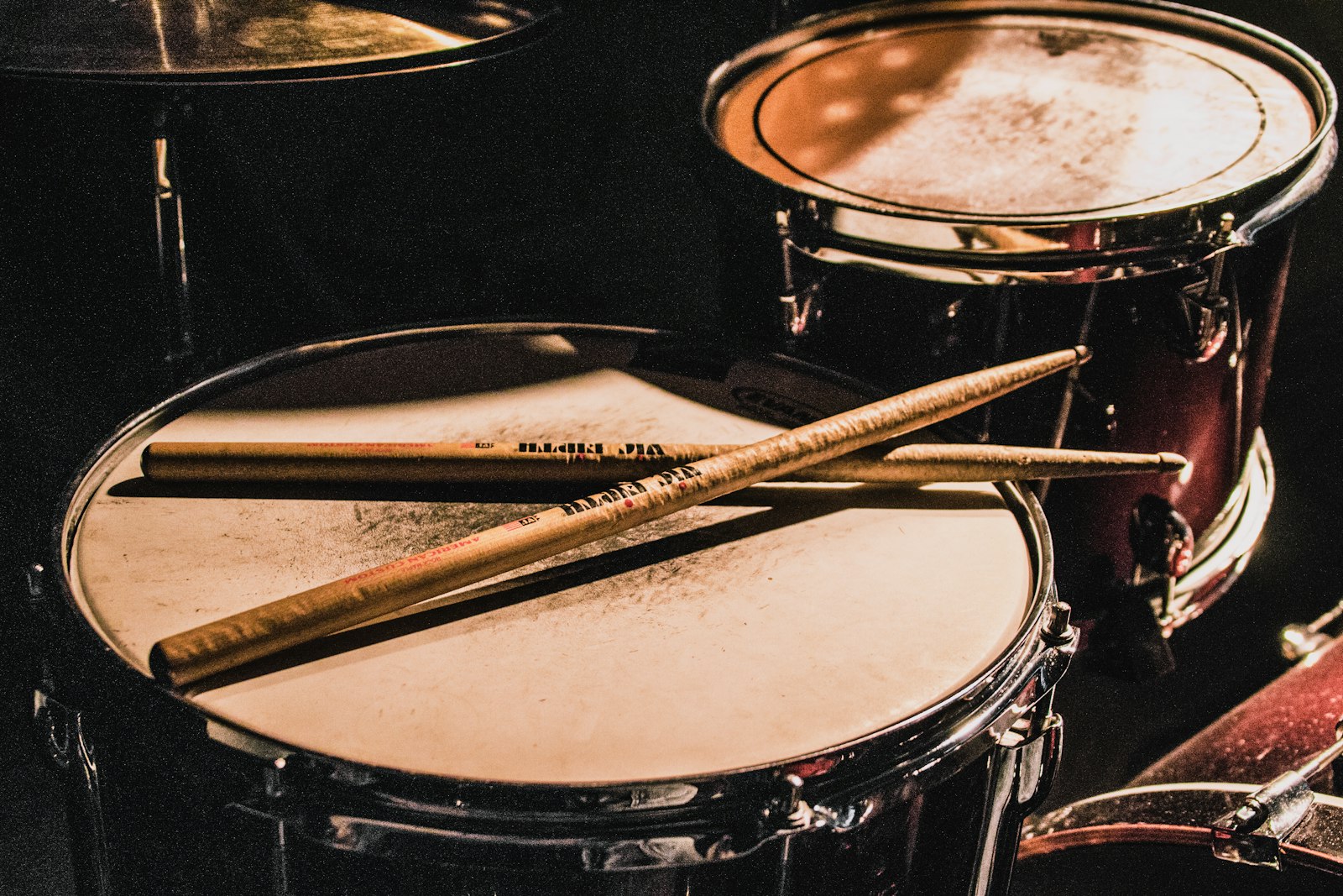 Drumsticks resting on a snare drum