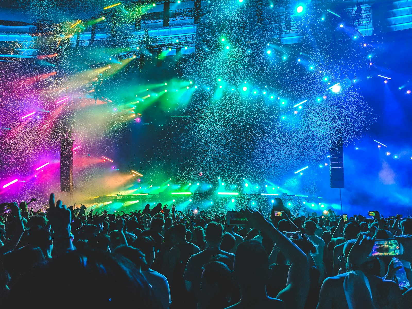 Cover art — a crowd under cyan and magenta lasers