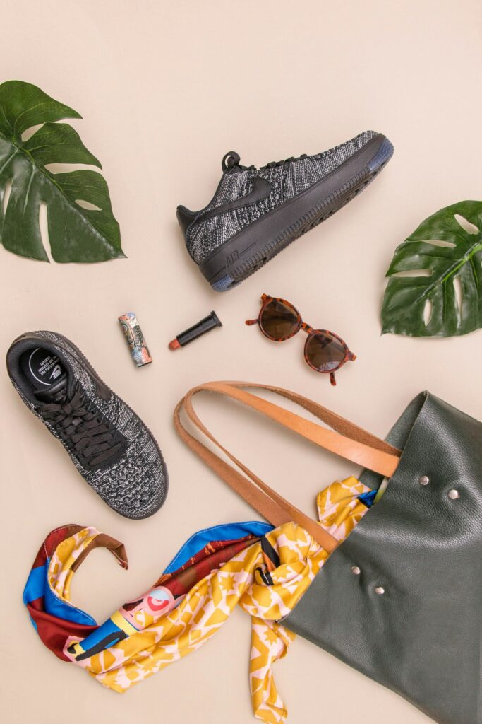 Flat-lay of sneakers, sunglasses and a bag