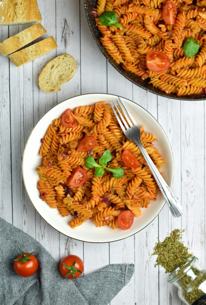 Fusilli pasta in tomato sauce with basil
