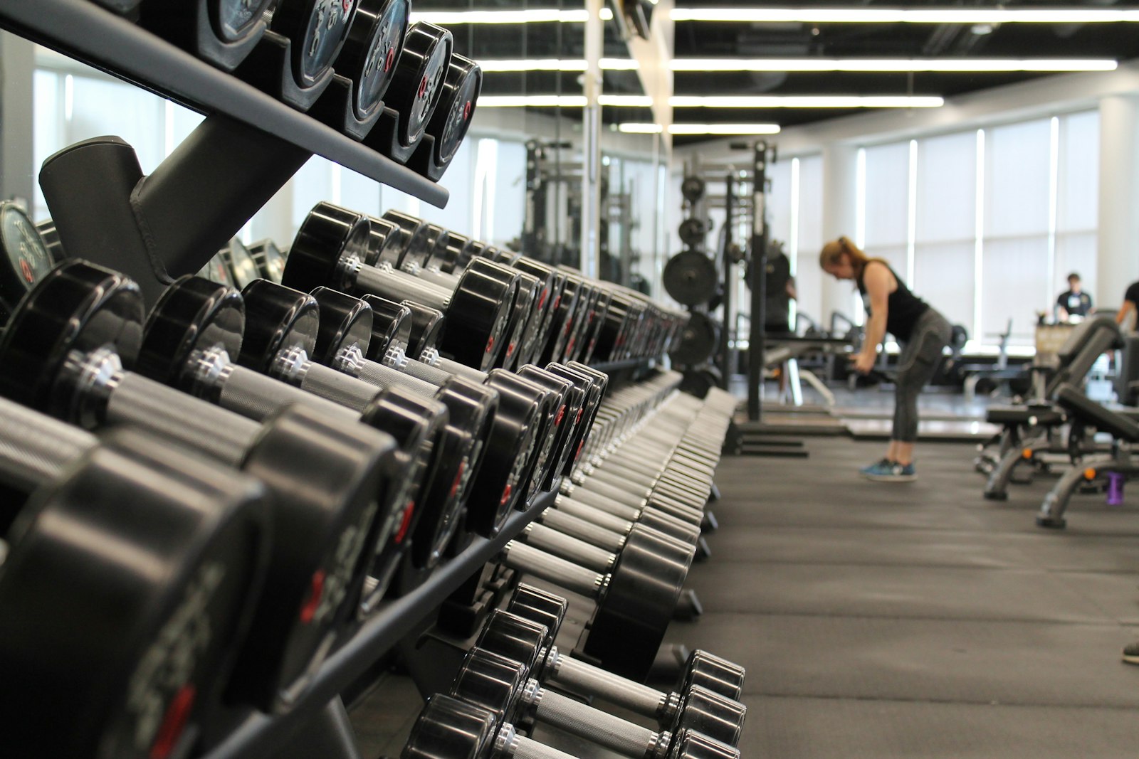 Barbell racks in a dark gym