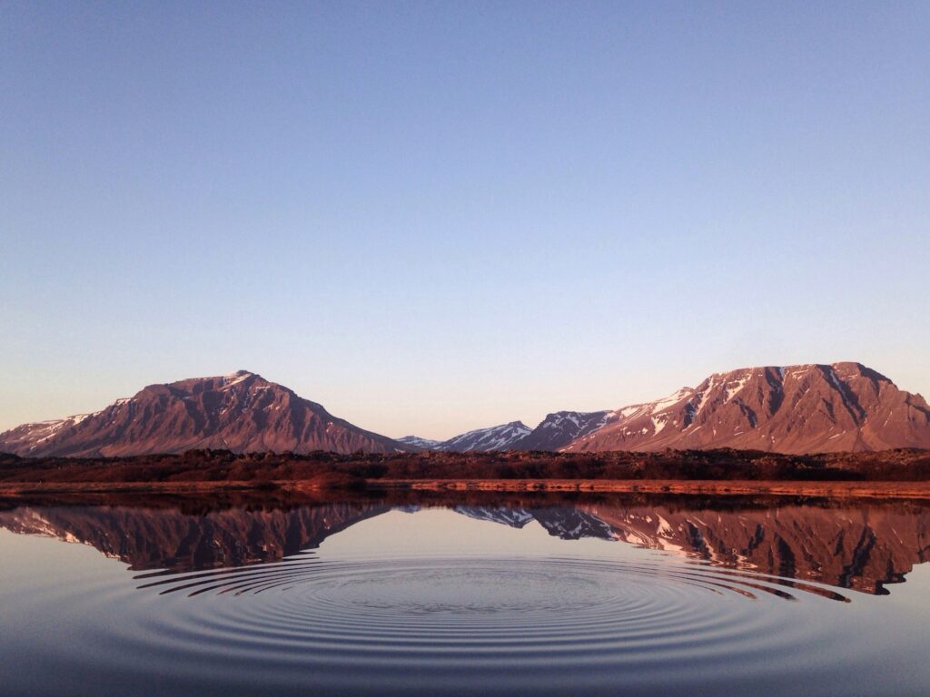 Mountains reflected in a rippled still lake