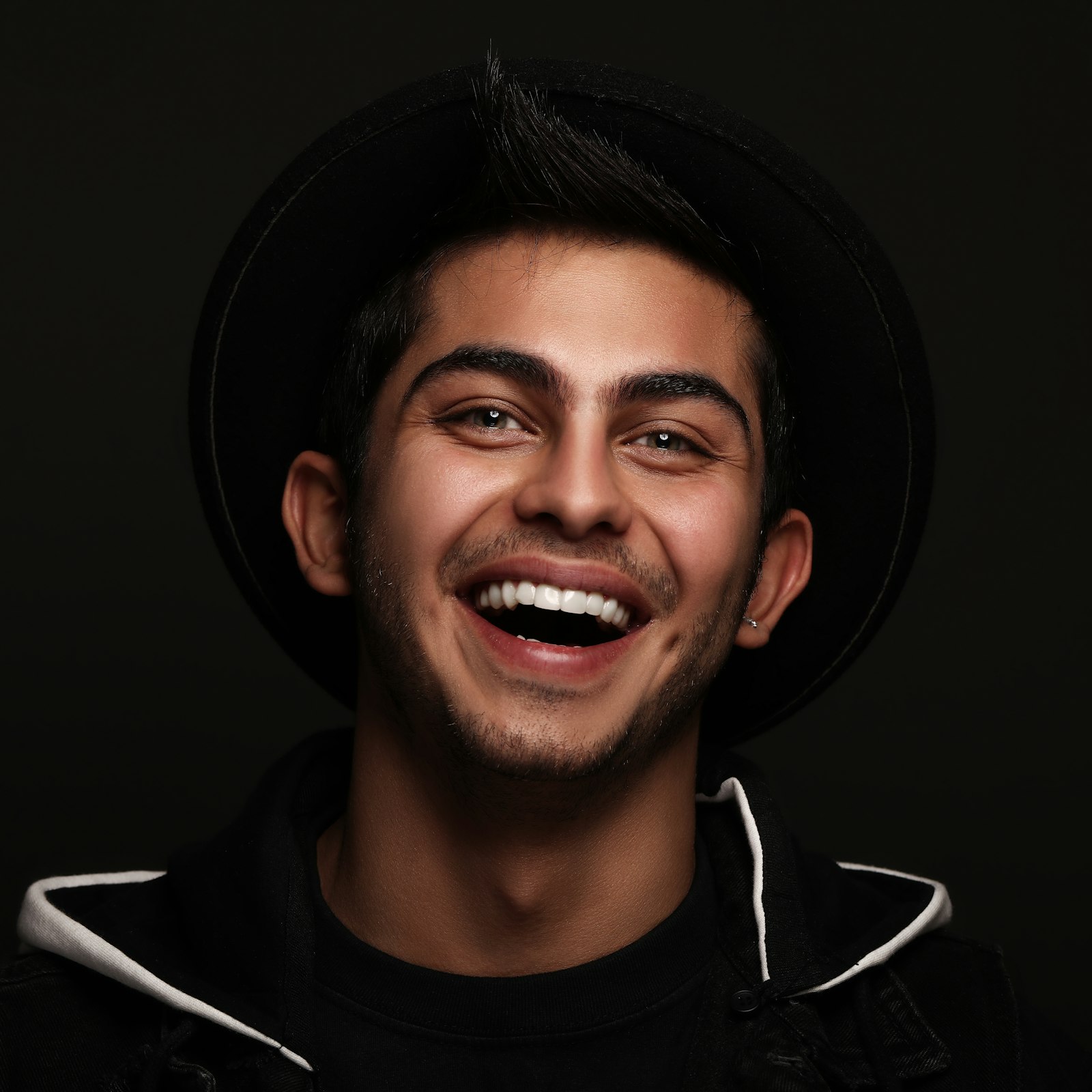 Laughing man against a dark backdrop