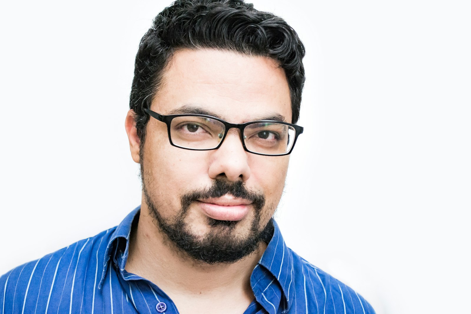 Bearded man with glasses in striped shirt