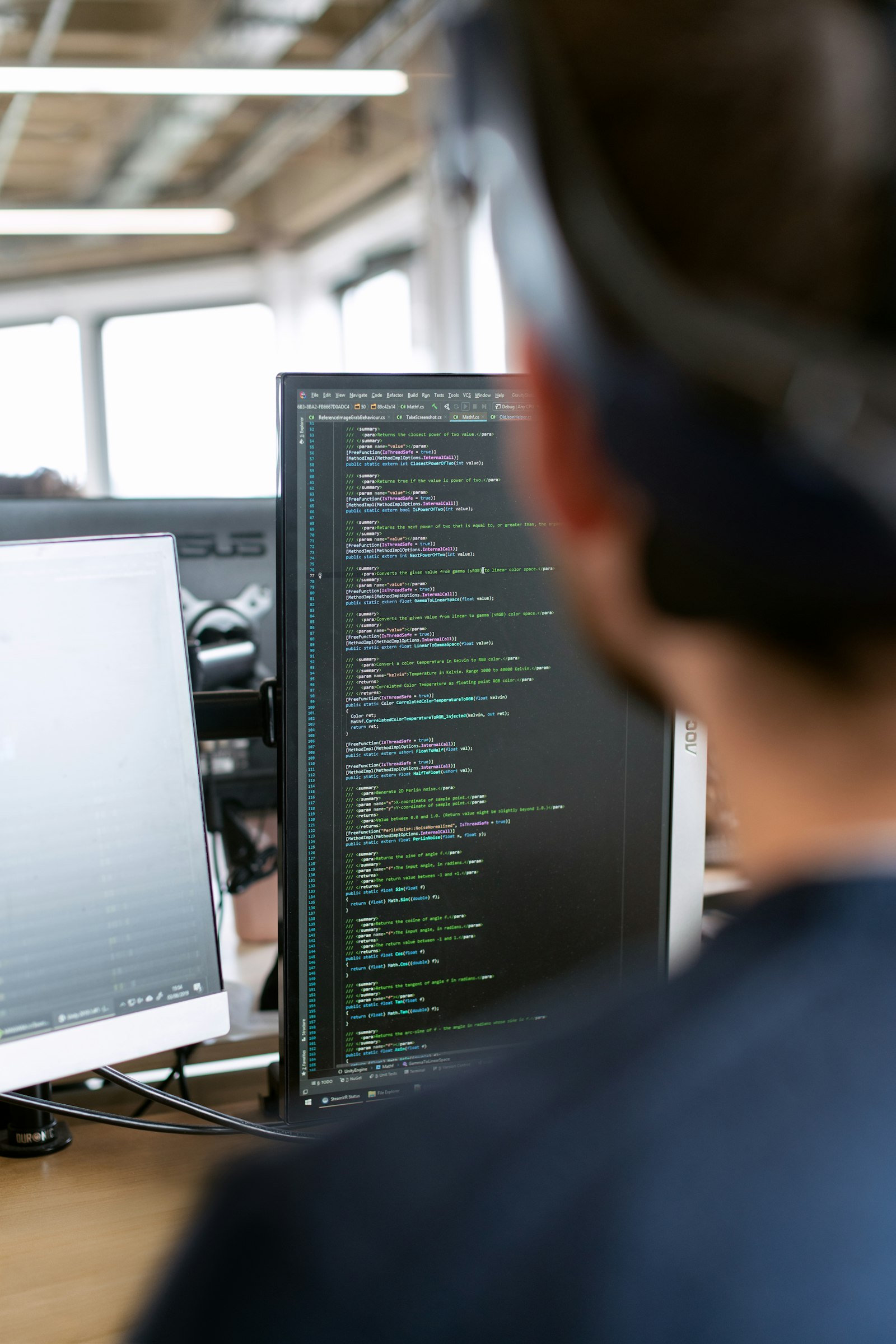 Engineer at a multi-monitor workstation