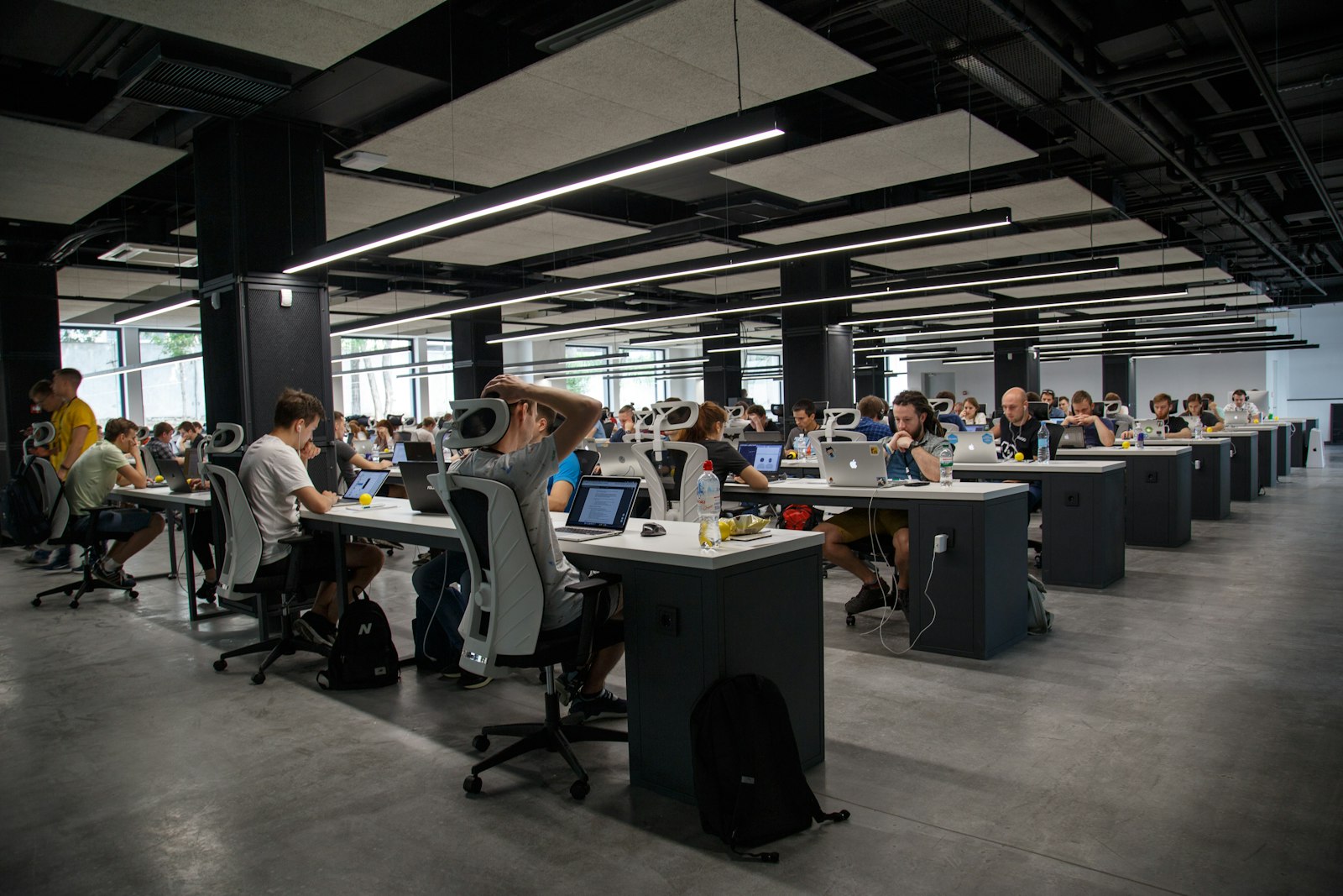 Rows of desks in a busy open-plan office