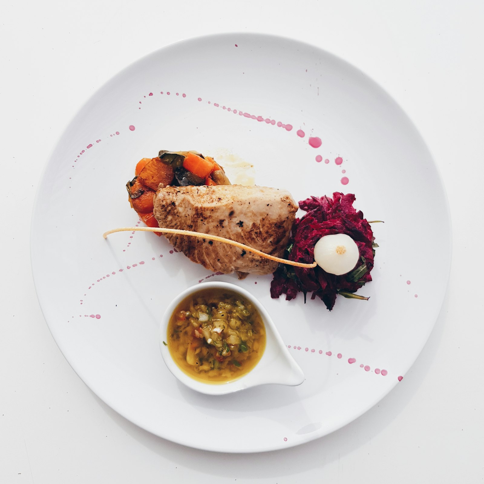 Plated fillet with vegetables and sauce jug