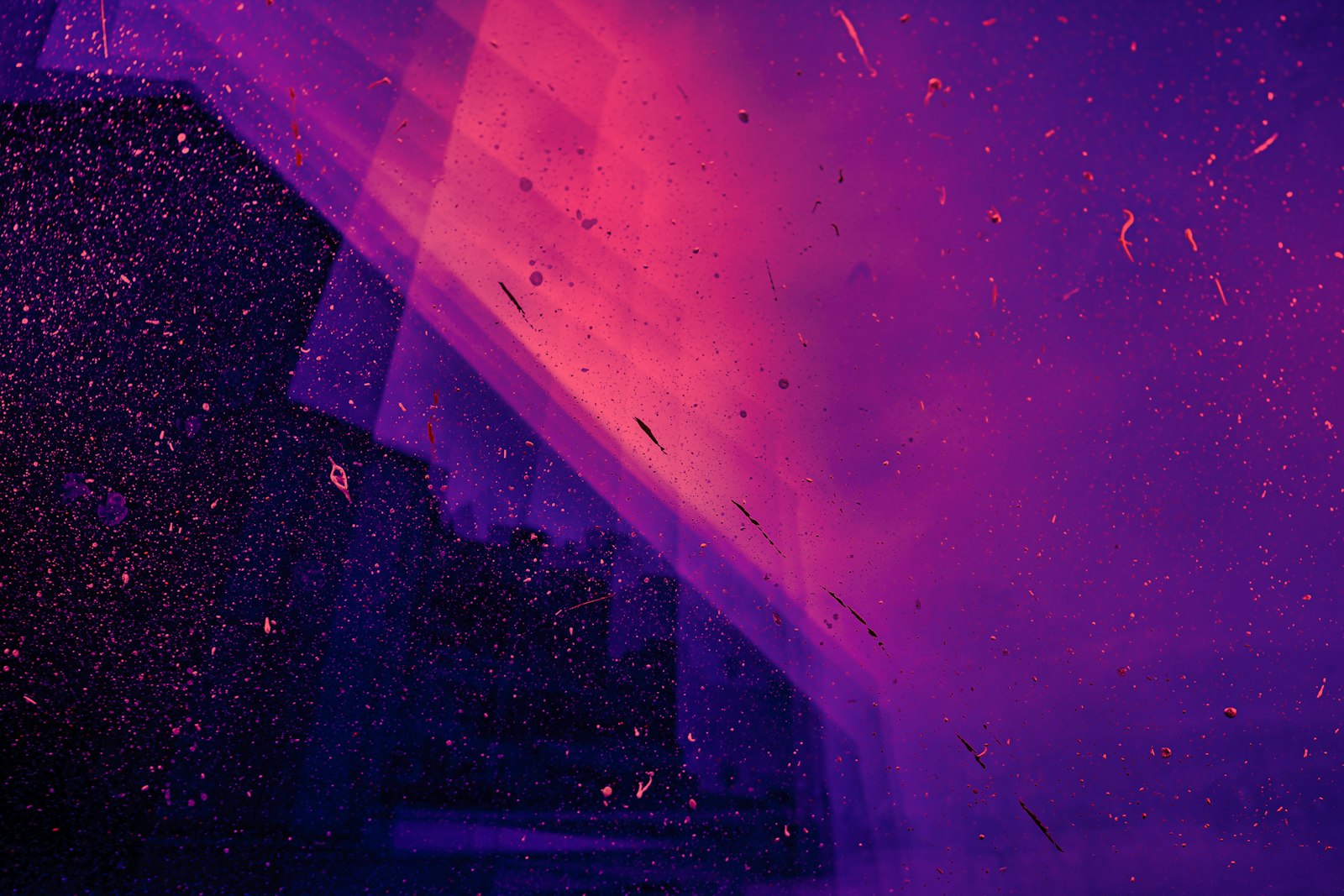 Purple haze with drifting sparks and light streaks