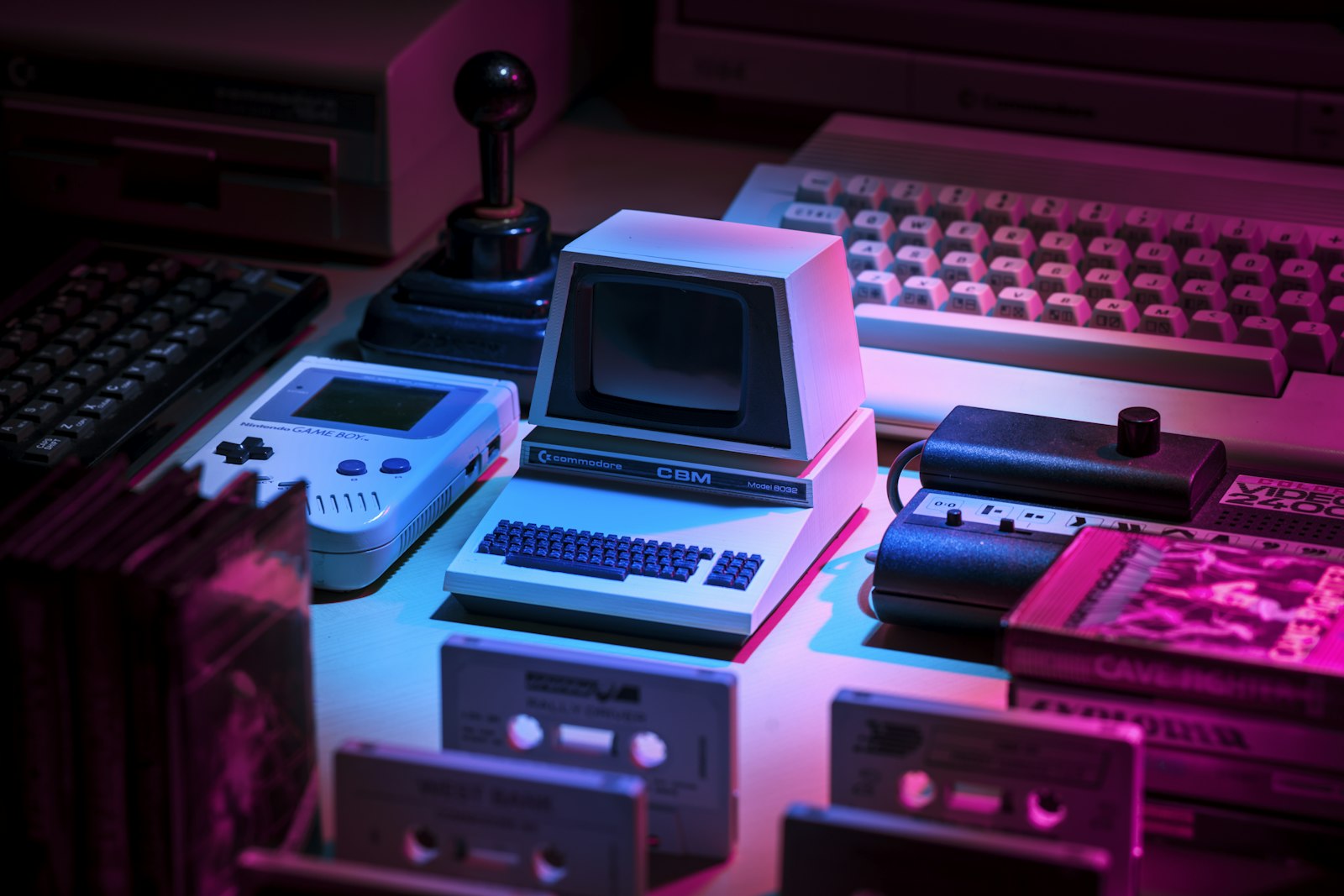 Retro computers and cassette tapes under neon light