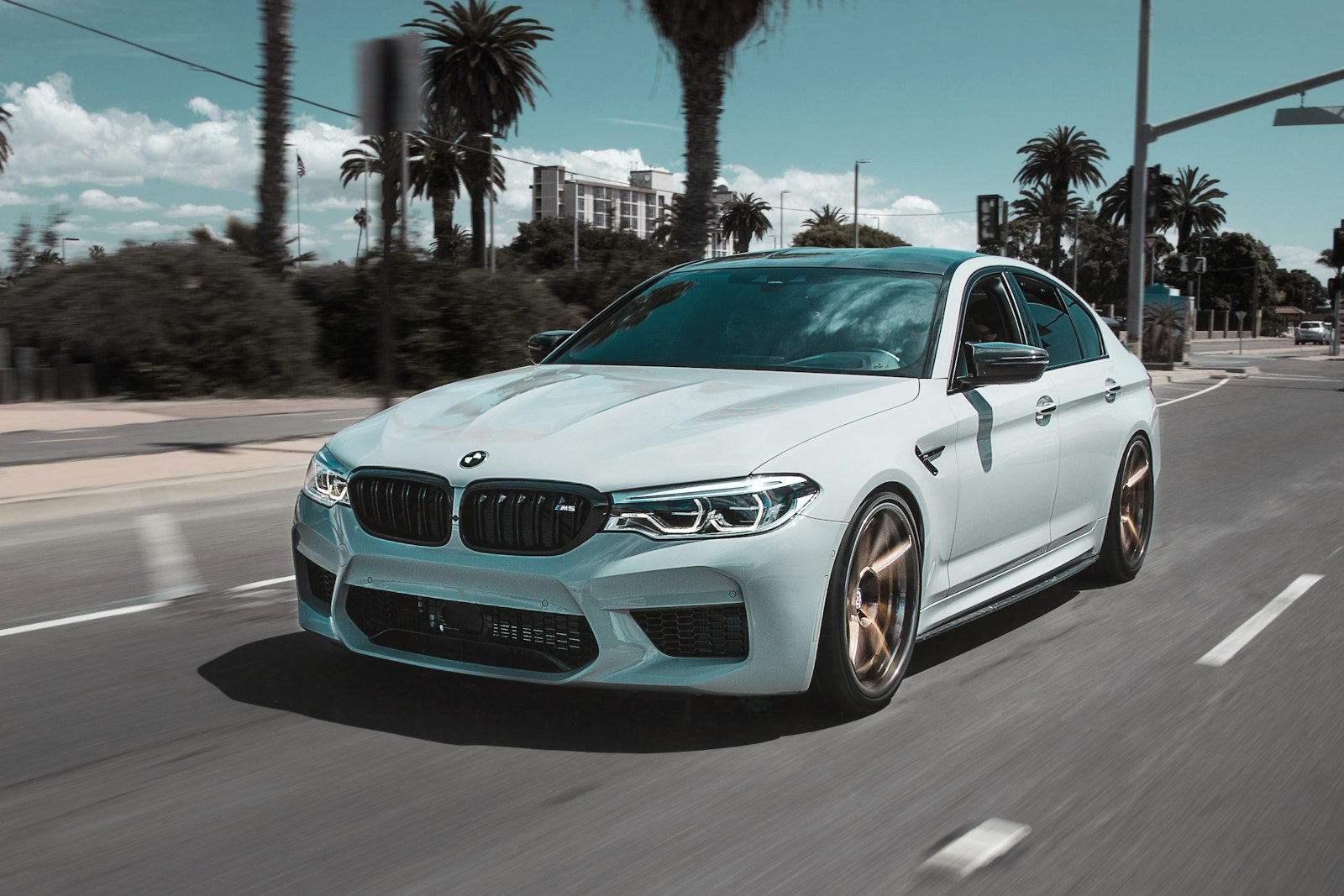 White performance sedan in motion