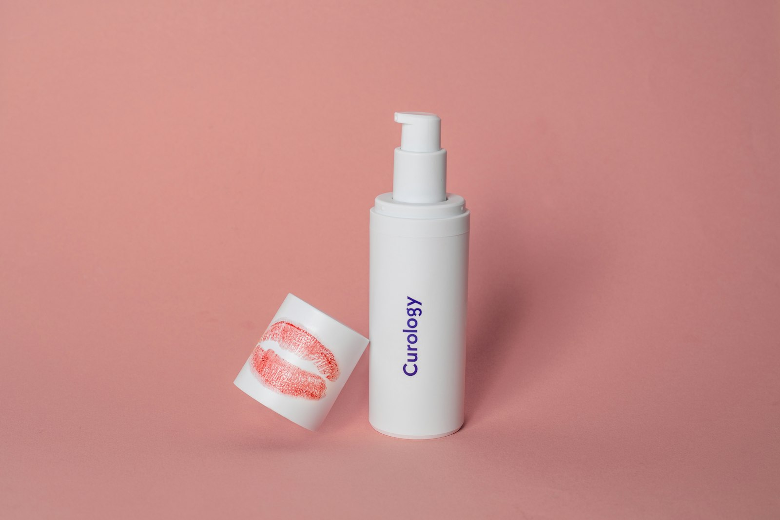 Skincare serum bottle on a pink backdrop