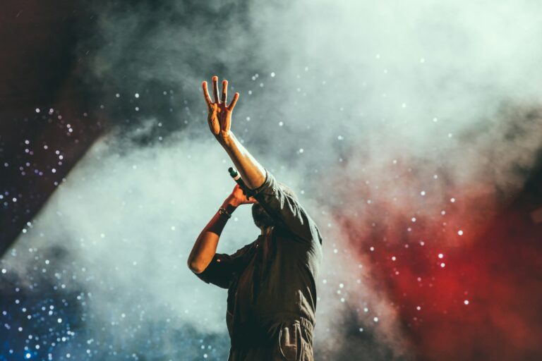 Singer in red stage smoke