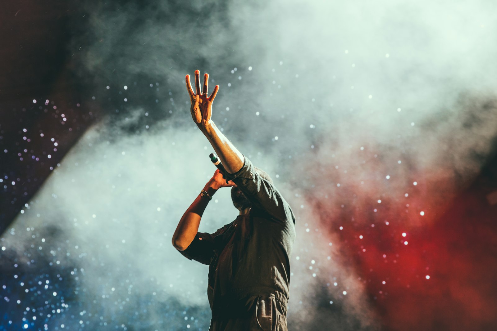 Singer in red stage smoke