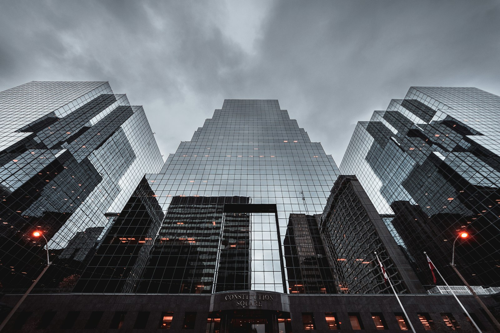 Glass skyscrapers under a stormy grey sky