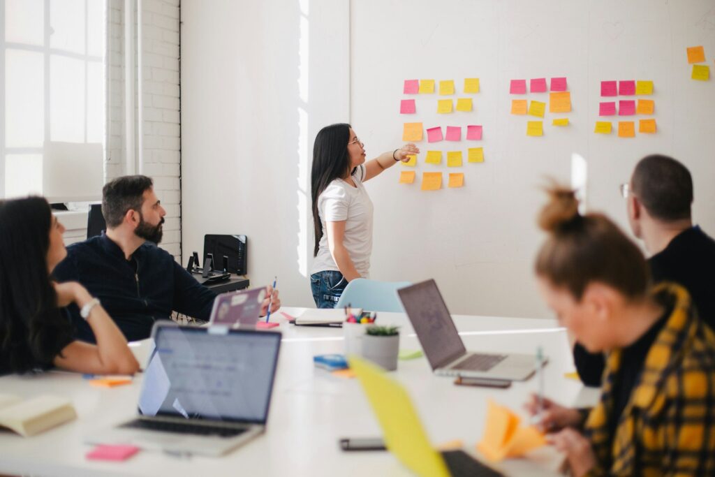 Woman pointing at sticky notes during a team session