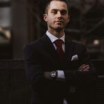 Man in dark suit with arms crossed