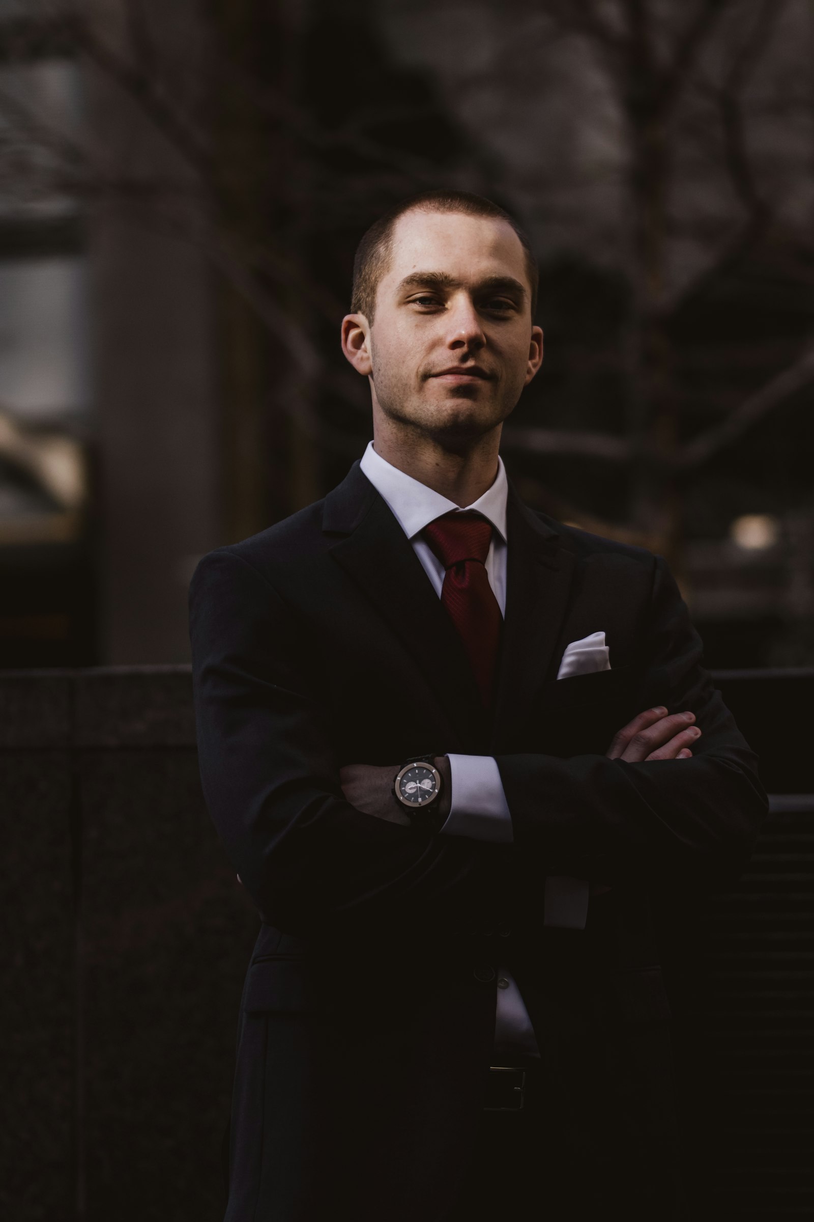 Man in dark suit with arms crossed