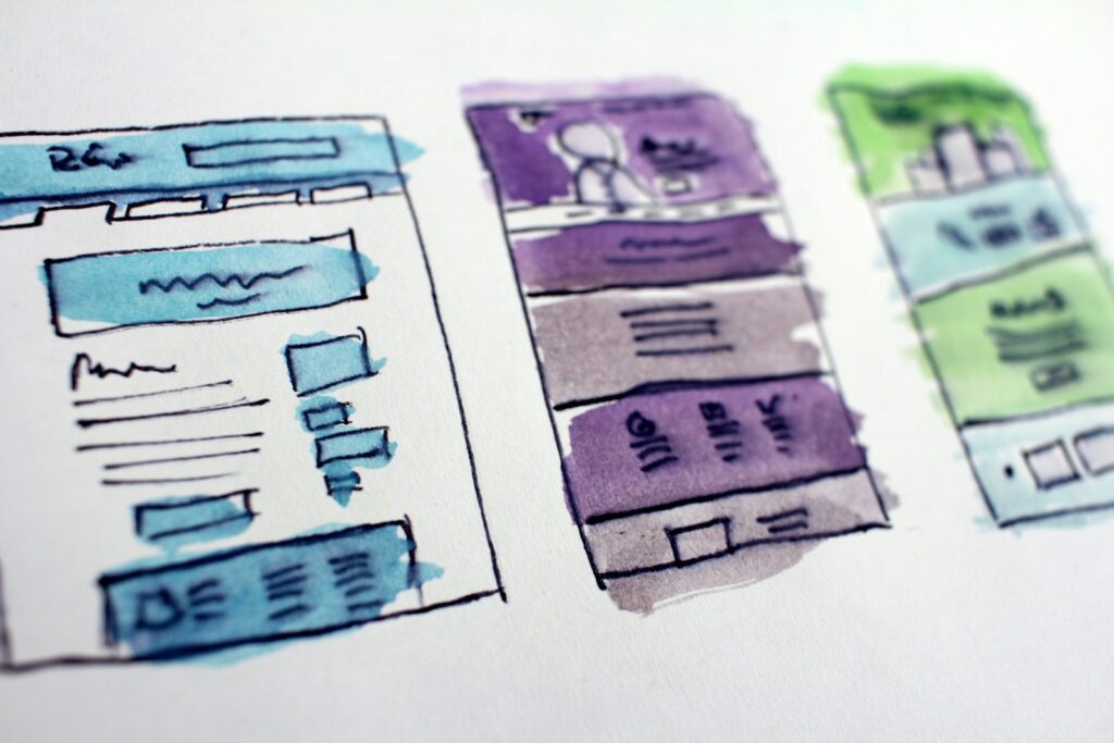 Hand-drawn website wireframes coloured with markers