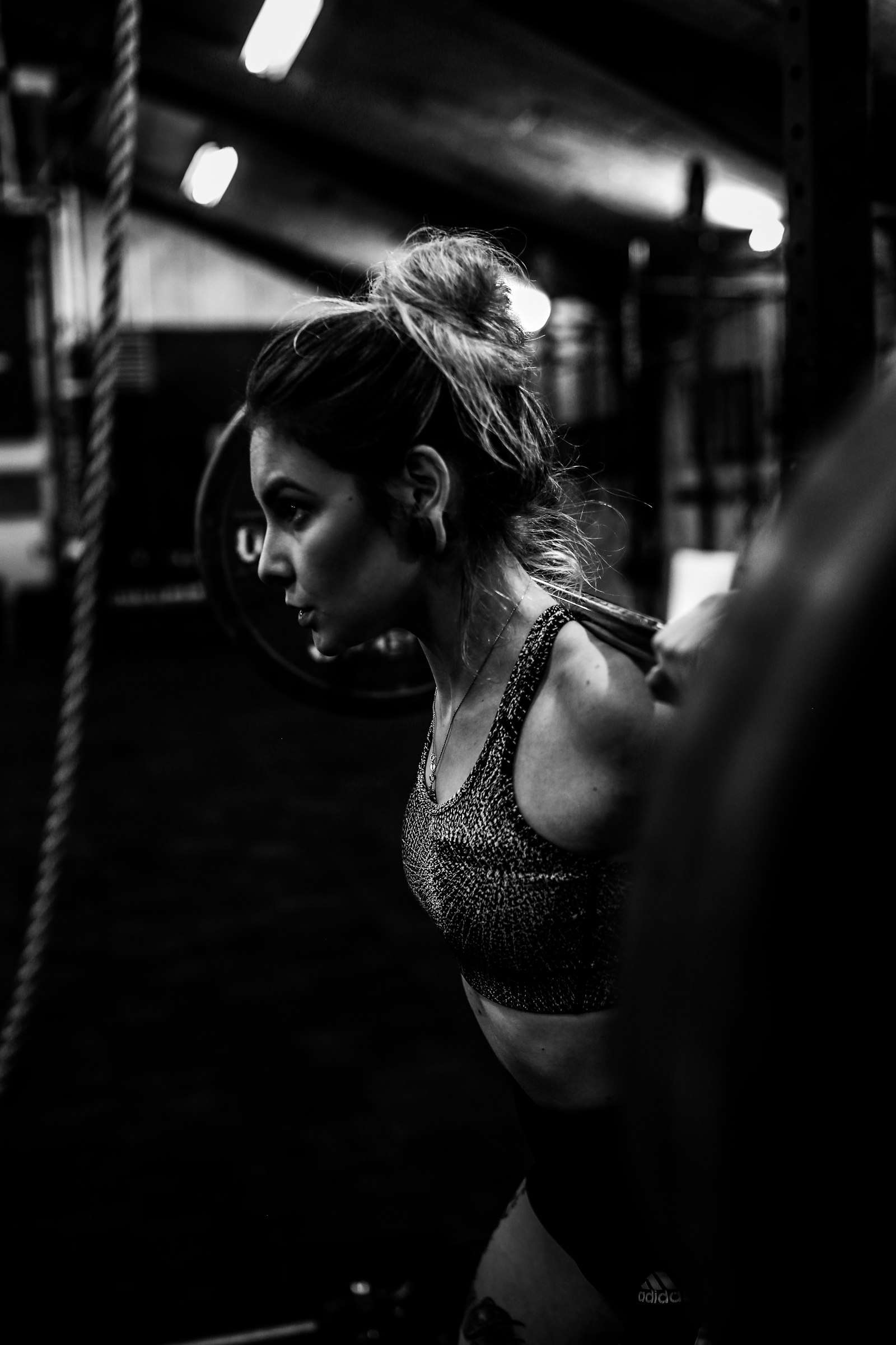 Woman with a barbell across her shoulders