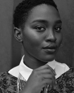 Woman with cropped hair in printed collared shirt
