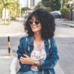 Smiling woman in a denim jacket on the street