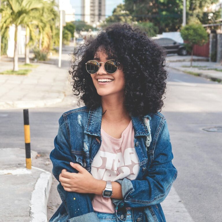 Smiling woman in a denim jacket on the street