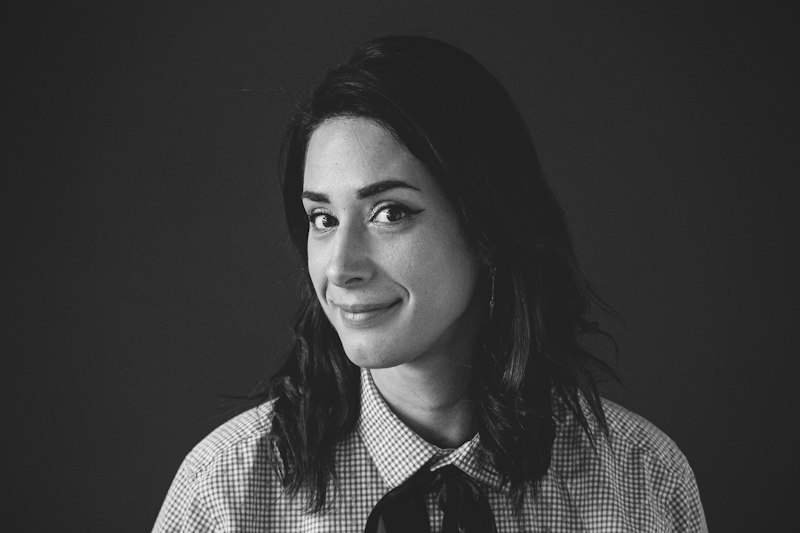 Confident woman against a dark backdrop