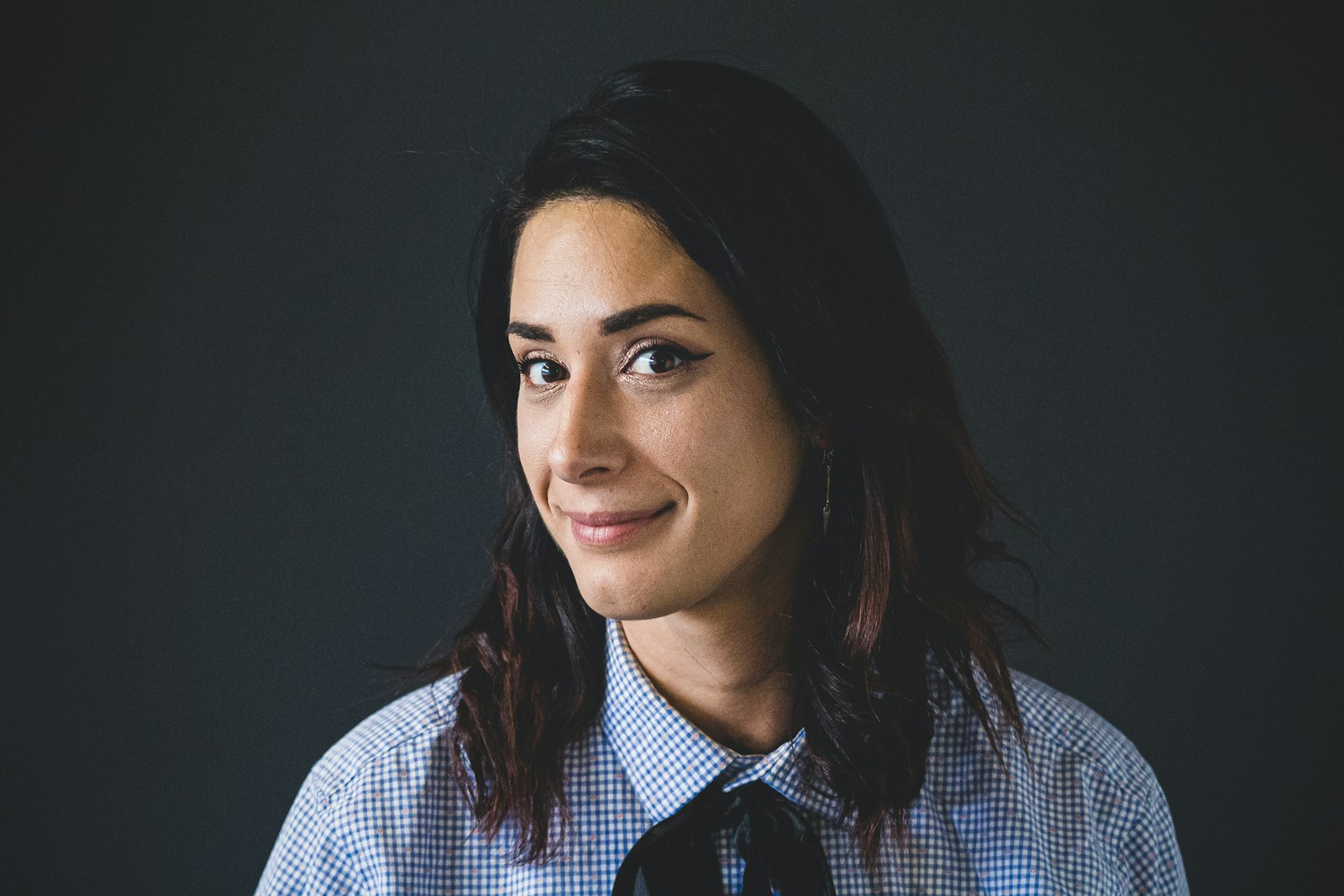 Confident woman against a dark backdrop