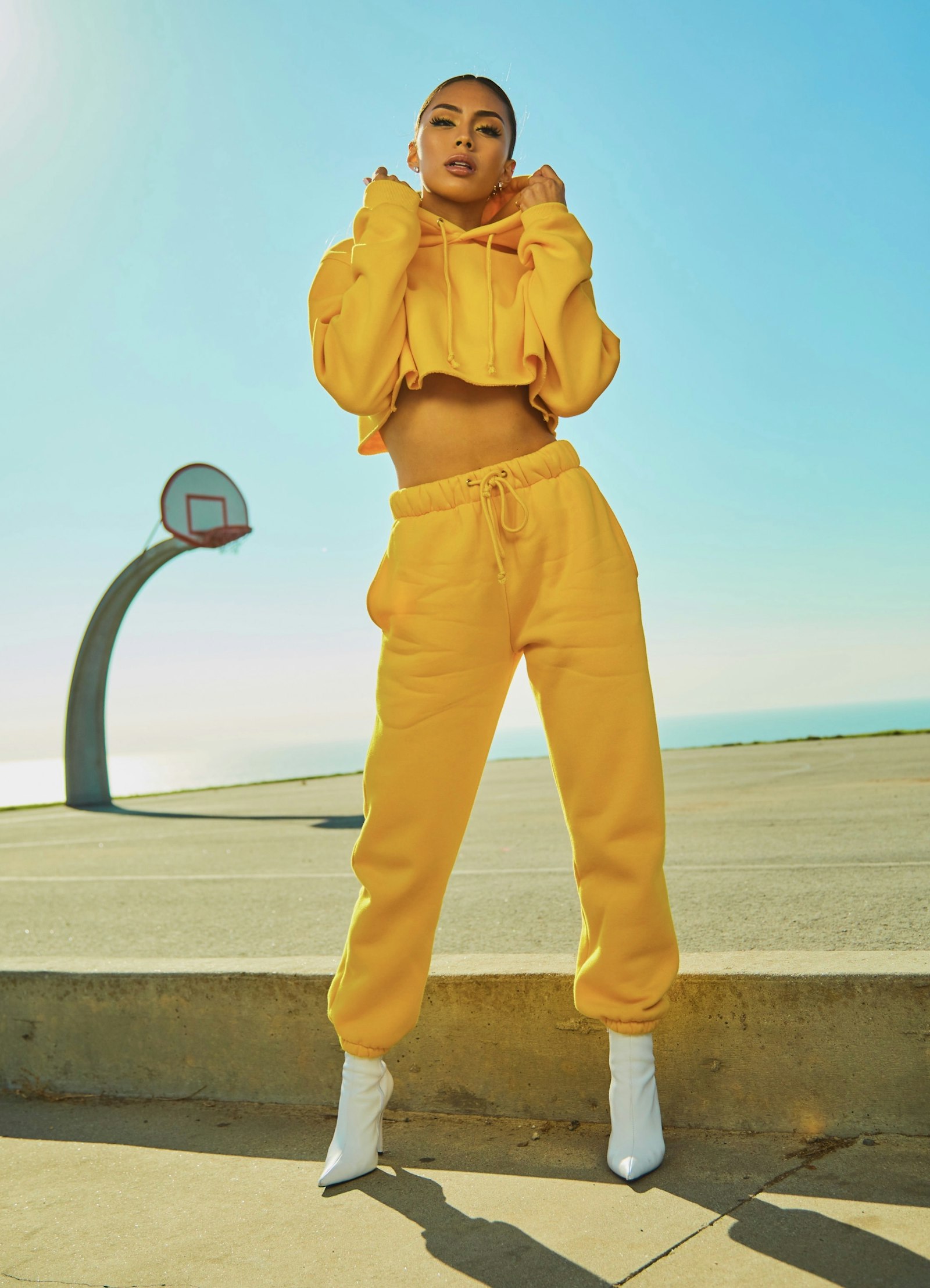 Woman in yellow tracksuit on a basketball court